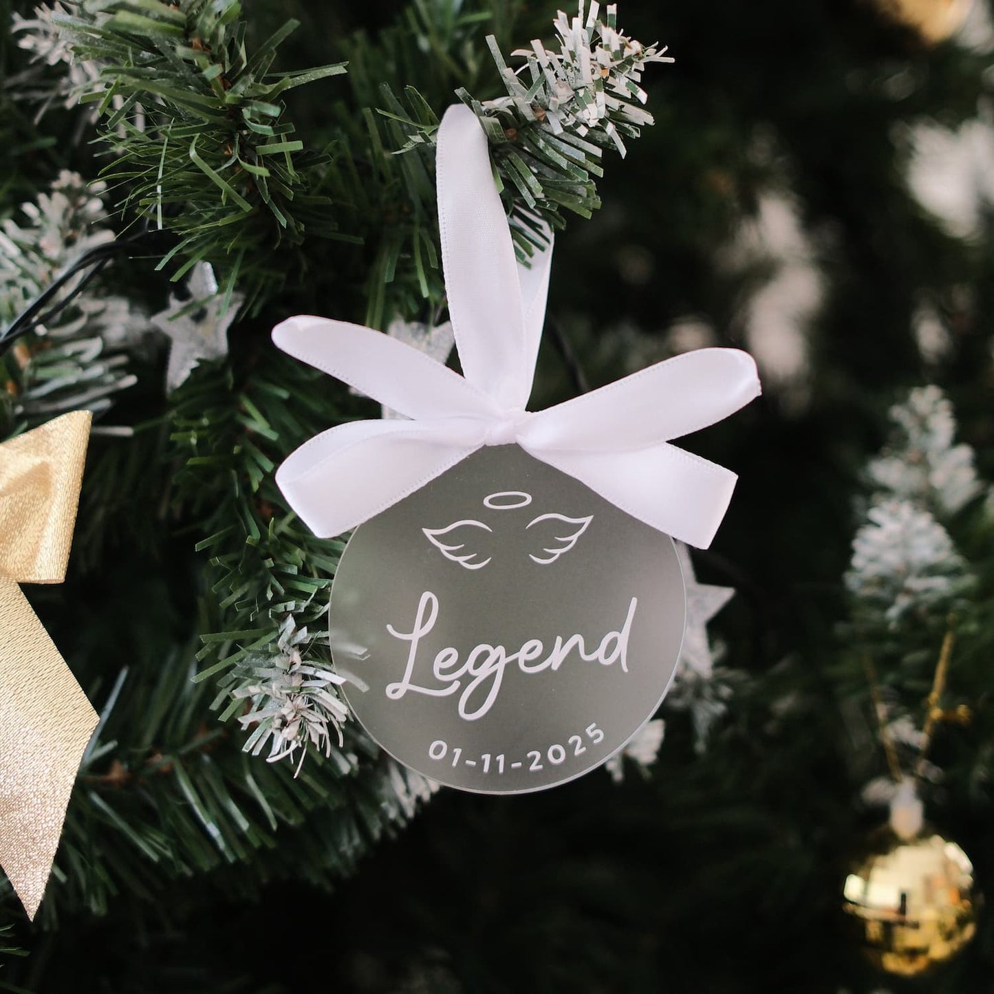 Decorative ornament with 'Legend' and date on a Christmas tree