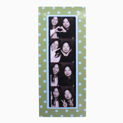 Collage of a woman making various poses on a green polka dot magnetic photo booth frame