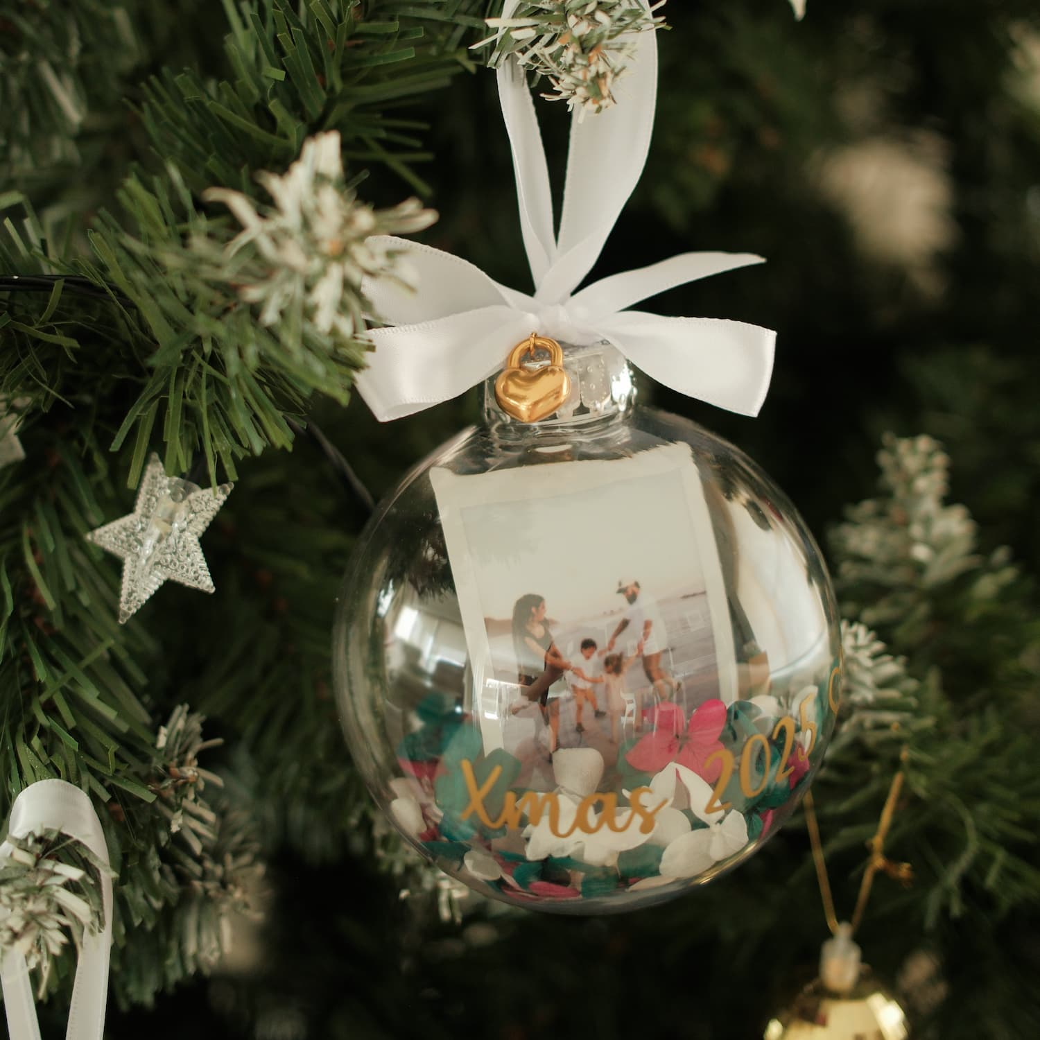 Polaroid Bauble Christmas ornament with a photo inside, hanging on a tree.