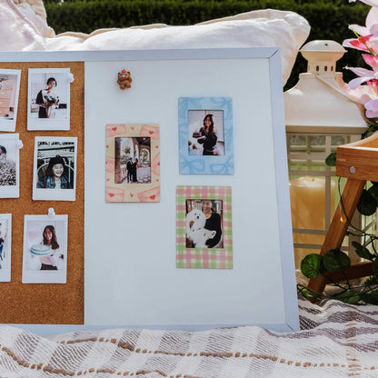 magnetic photo frame collage with a mix of printed and framed photos on a decorative surface.