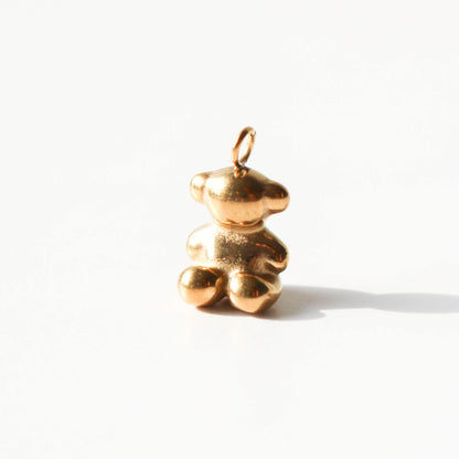 Gold bear-shaped pendant on a white background