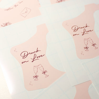 Pink kodak disposable camera wraps with 'Drunk on Love' text and champagne glass design on a light pink background.