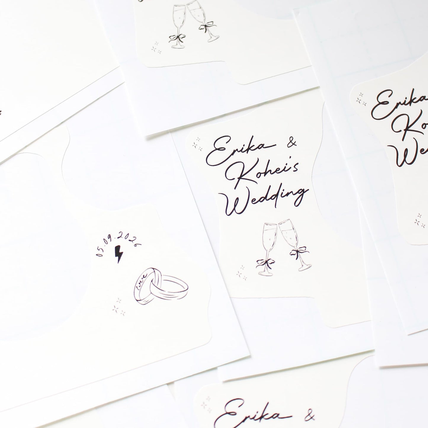 Set of personalized wedding kodak disposable camera wraps with 'Erika & Kohe's Wedding' text on a white background.