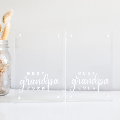Two clear acrylic blocks with 'Best Grandpa Ever' text and a jar with dried plants on a light background.