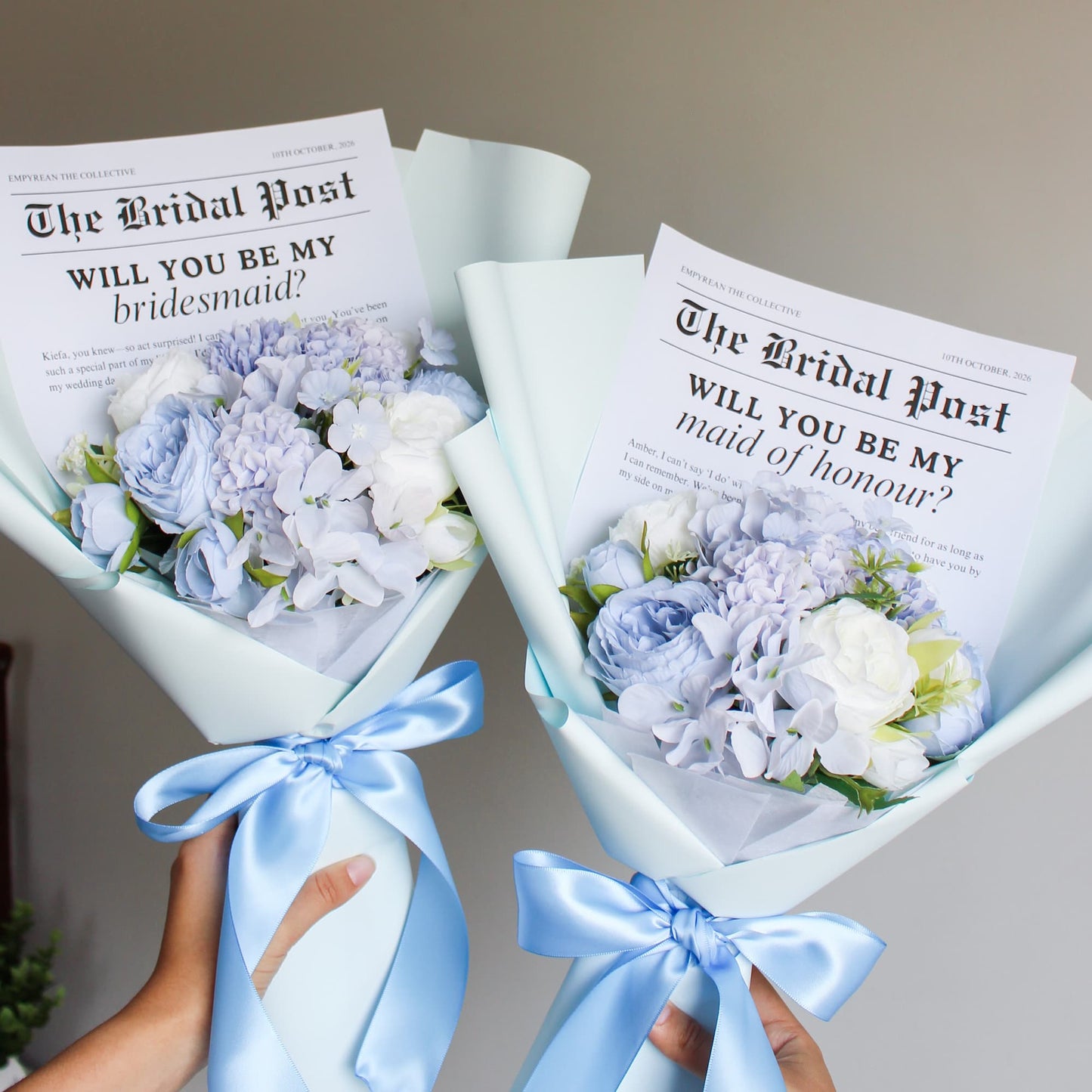 Two bouquets of flowers with 'Will you be my bridesmaid?' and 'Will you be my maid of honour?' cards.