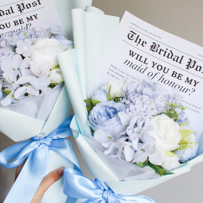 Floral arrangement with a 'Bridal Party' magazine asking 'Will you be my maid of honour?'
