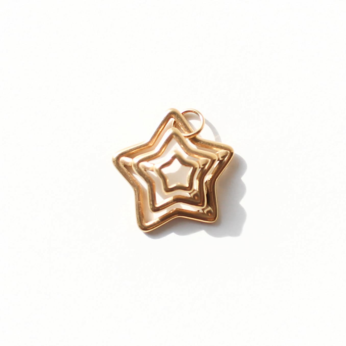 Gold star-shaped charm on a white background