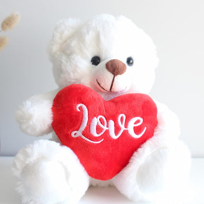 white bear holding red heart
