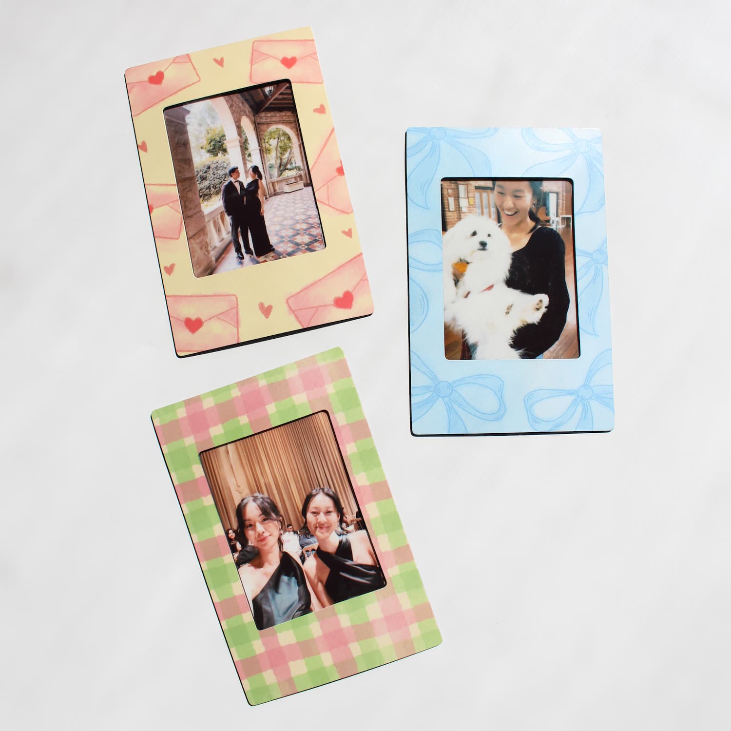 Three colorful magnetic photo frames with different designs on a white background