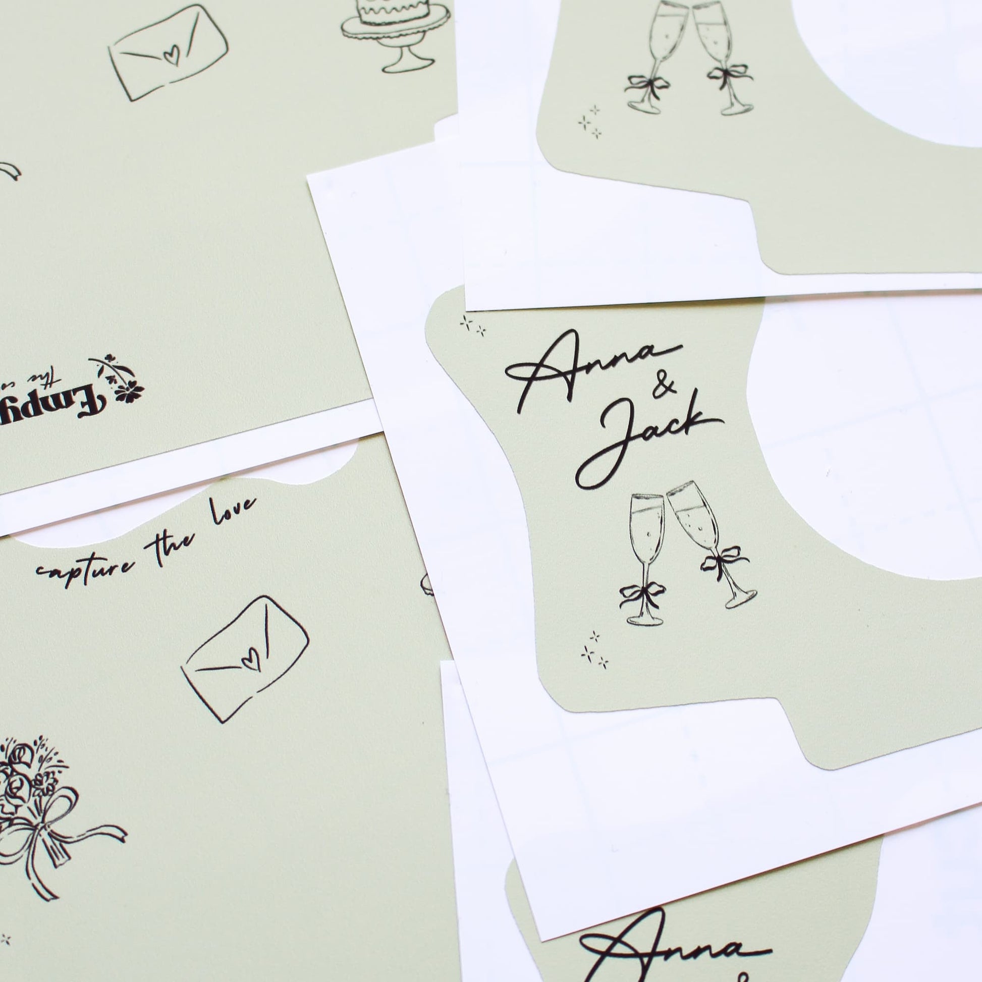 Collection of personalized kodak disposable camera wraps with names and decorative elements on a white background.